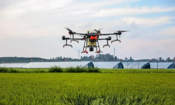 An inspection and sprayer drone patrolling a field.