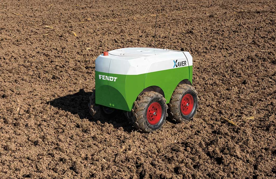 A Fendt mini-robot trundling across a ploughed field.