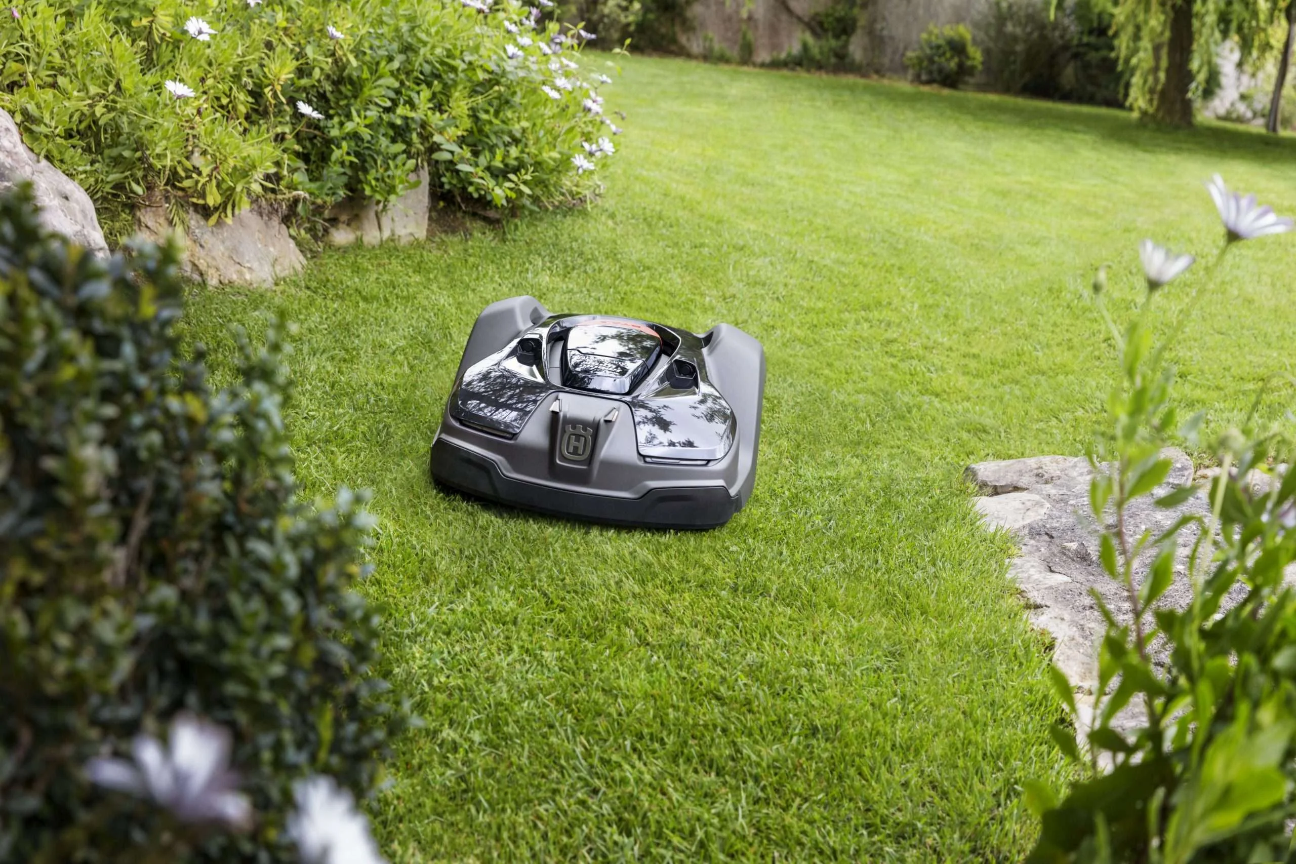 A domestic robot cutting the grass. The technology owes much to robotic farming.